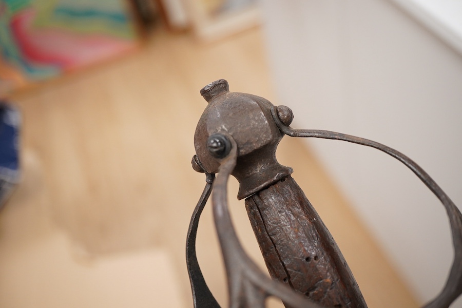 A basket hilted broadsword c.1640, later replacement blade, iron hilt of multi bars with remains of pierced guard, faceted pommel with its original wooden grip, wire covering missing, blade 79cm